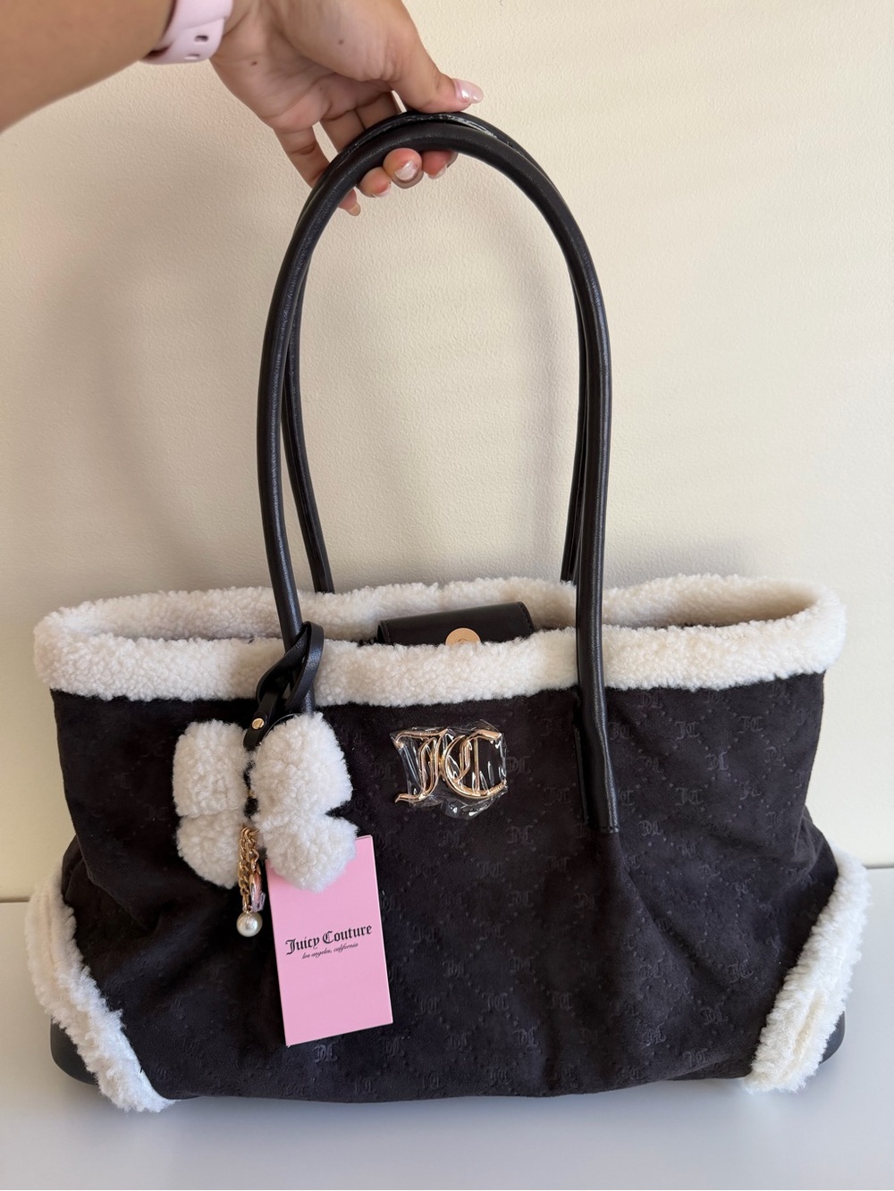 Back Juicy Couture tote bag with cozy white faux-fur trim and a matching charm